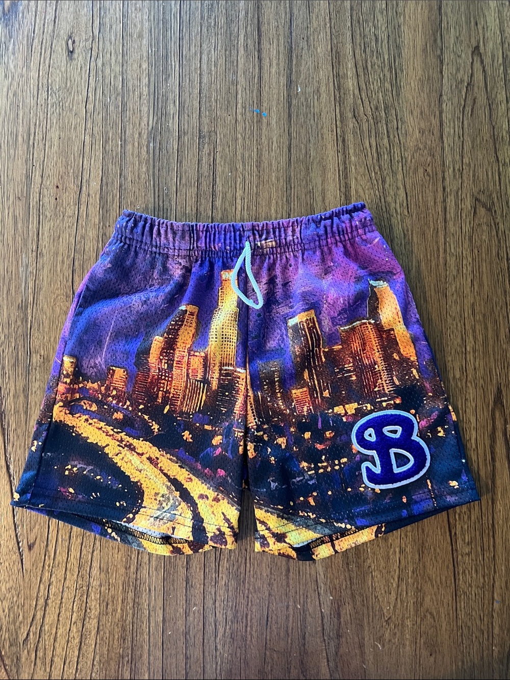 BKTSQD Los Angeles Purple Cityscape Basketball Shorts with 'B' Logo.